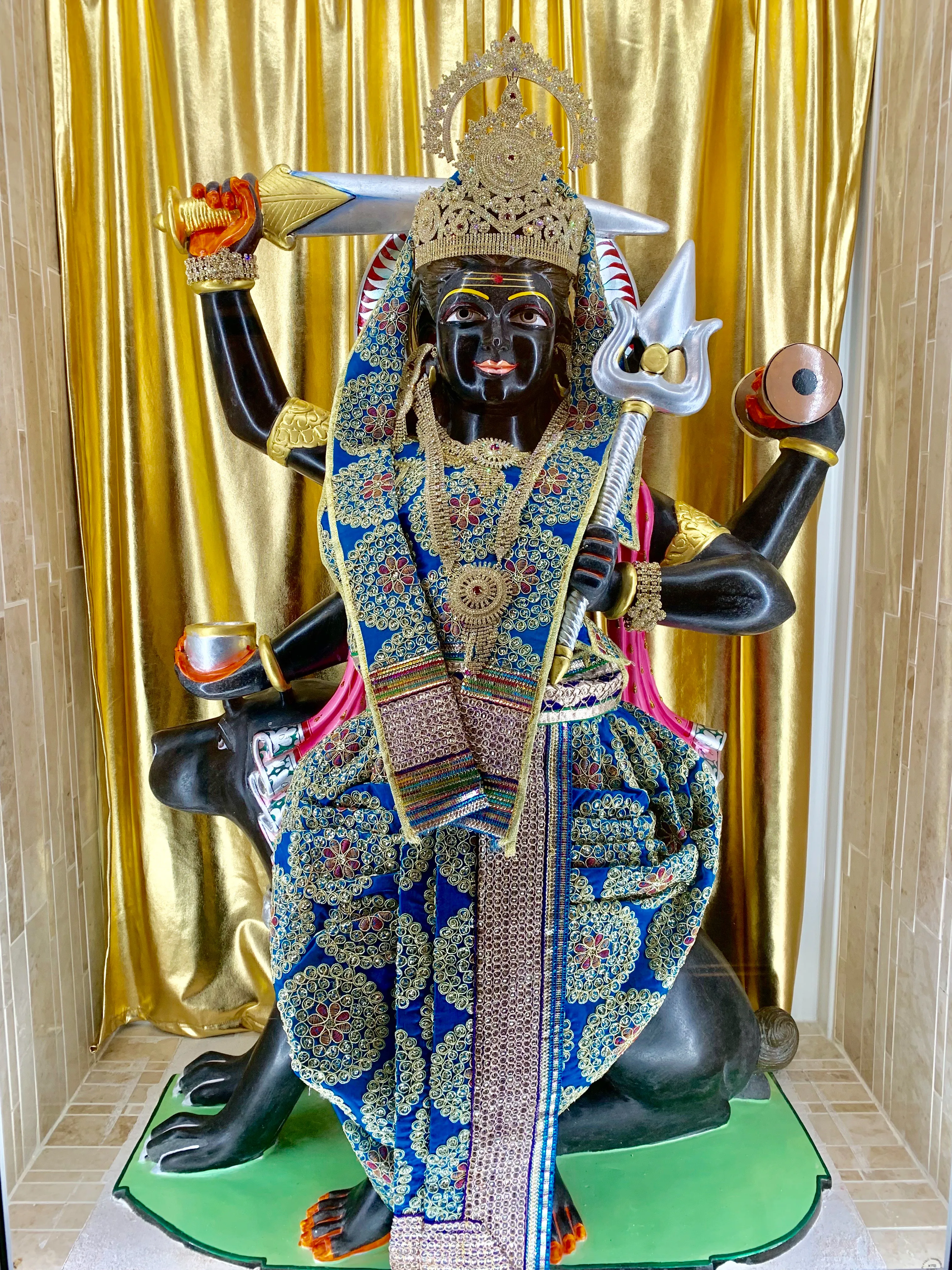 The murti of Bherunath — dark-skinned and many-armed, standing upon his dog, holding a trishul