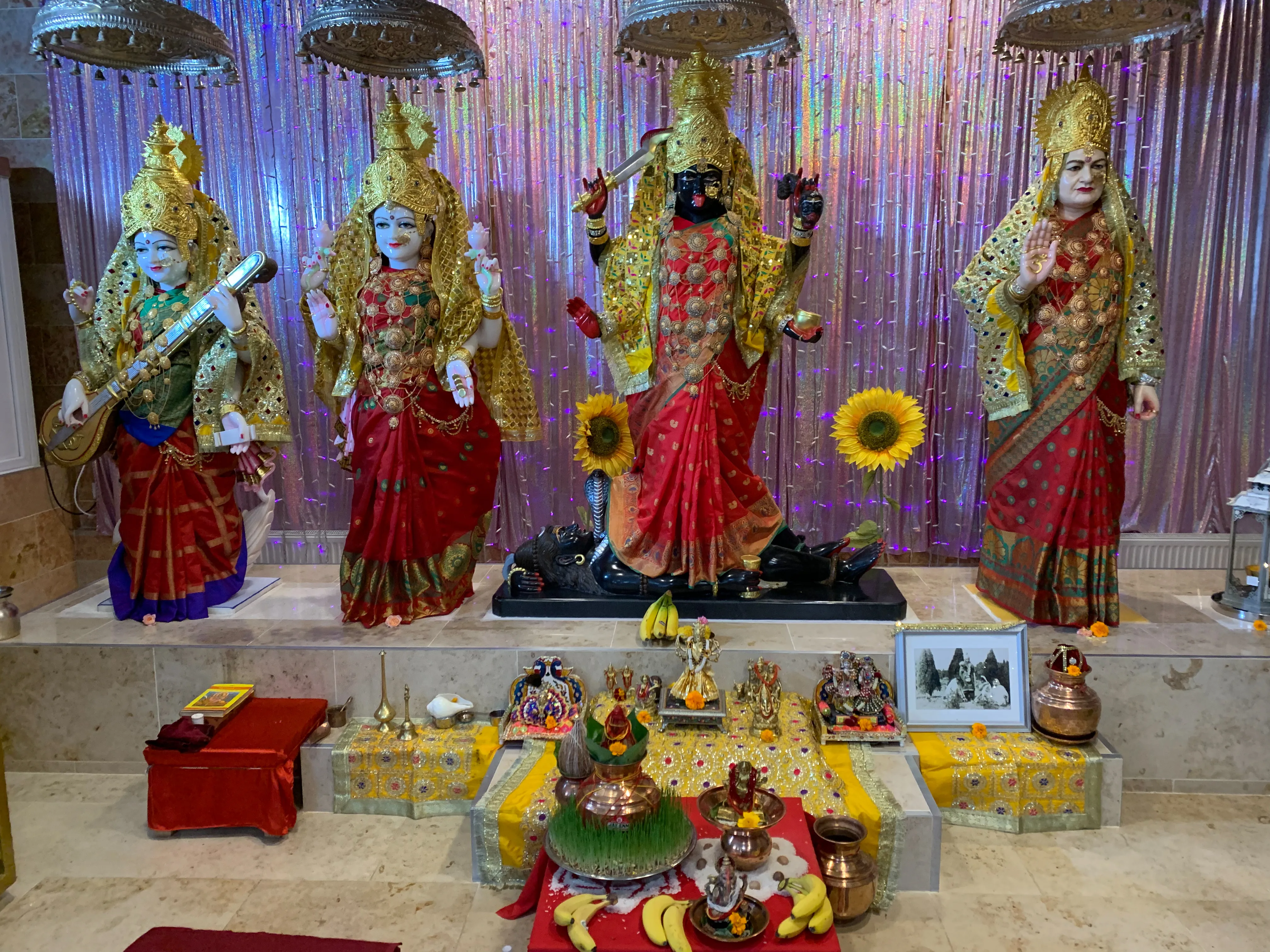 Inside the prayer hall — the main altar prepared with offerings