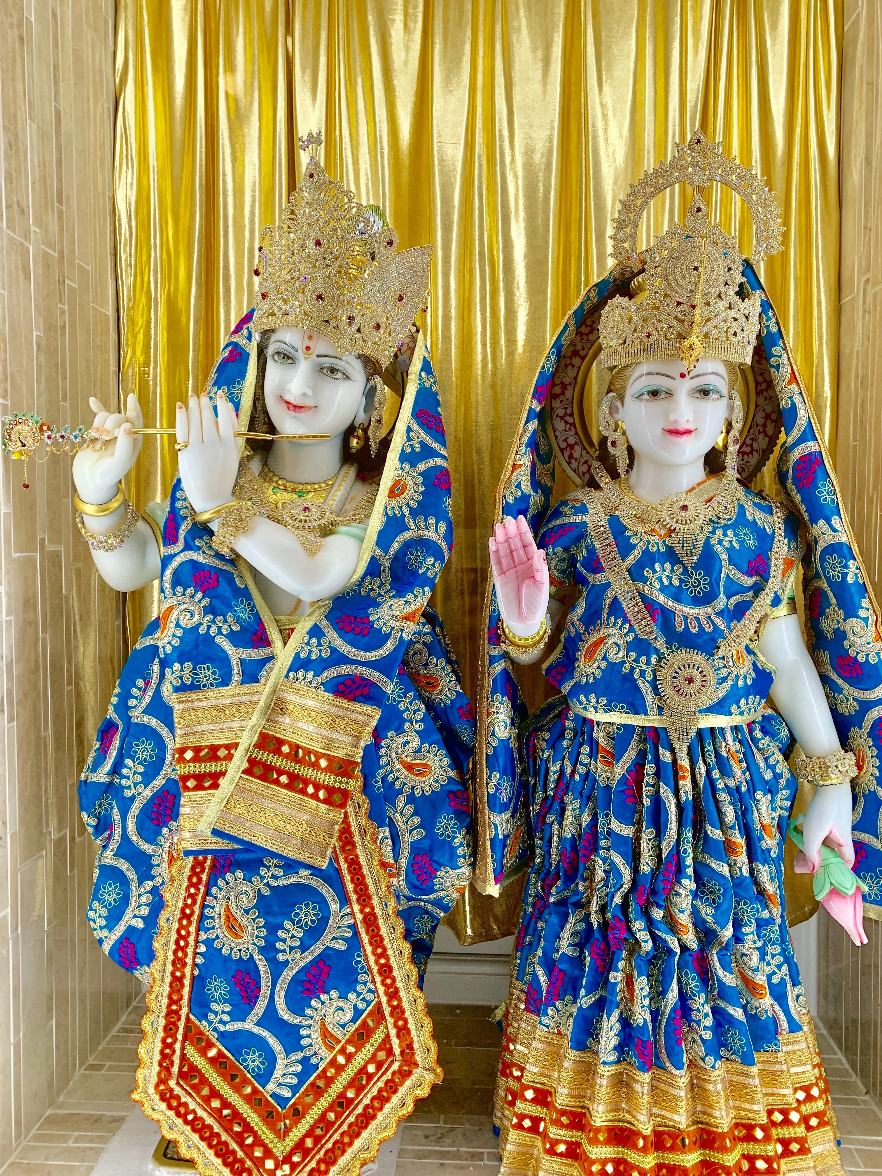 The murtis of Radha and Krishna dressed in blue