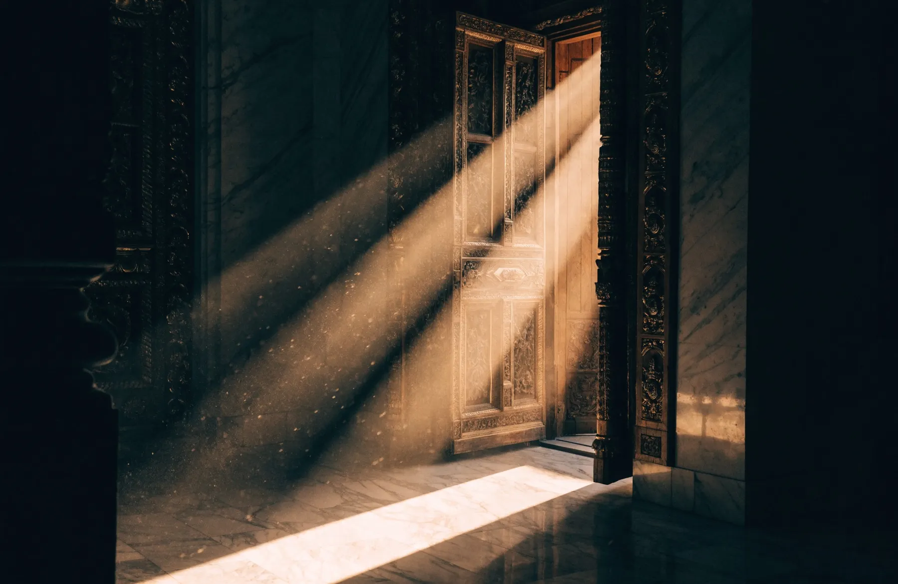 Shafts of golden light streaming through an open temple doorway into a dim hall